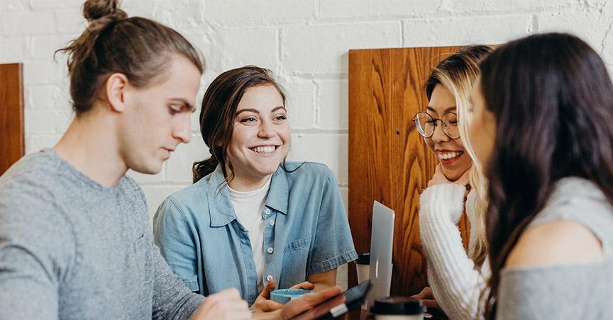 a group of coworkers close and smiling together