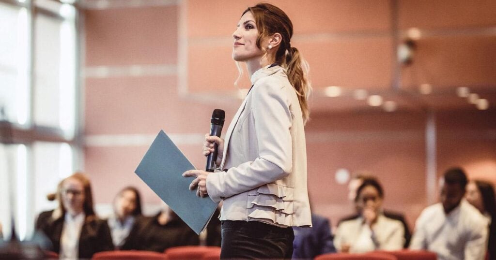 a women speaking in front of an audience