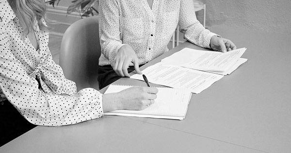 two women looking over paperwork