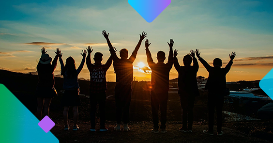 people holding up there hands watching the sun go down