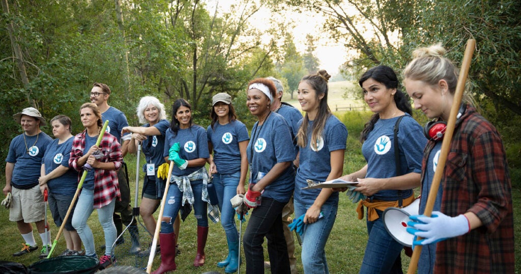 volunteers holding equipment smiling