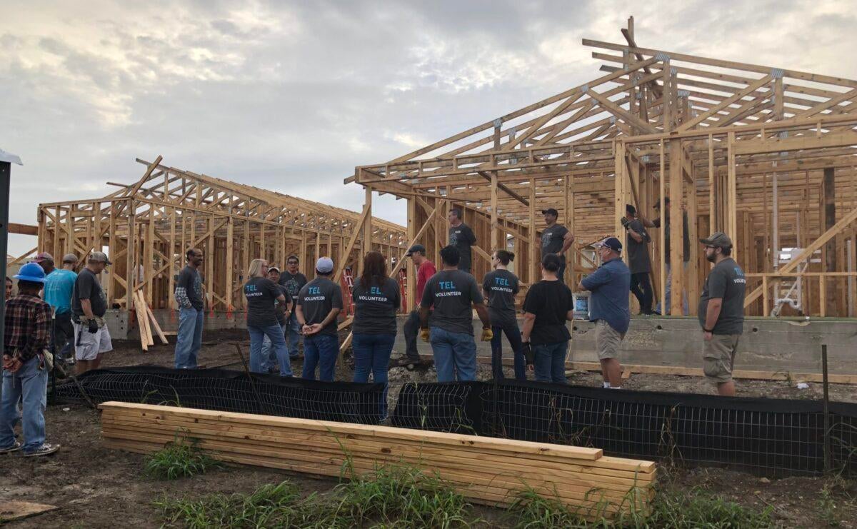 TEL volunteers building houses