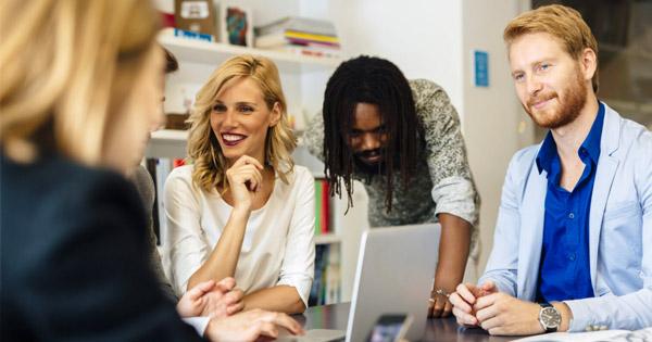 a group of colleagues smiling around a table