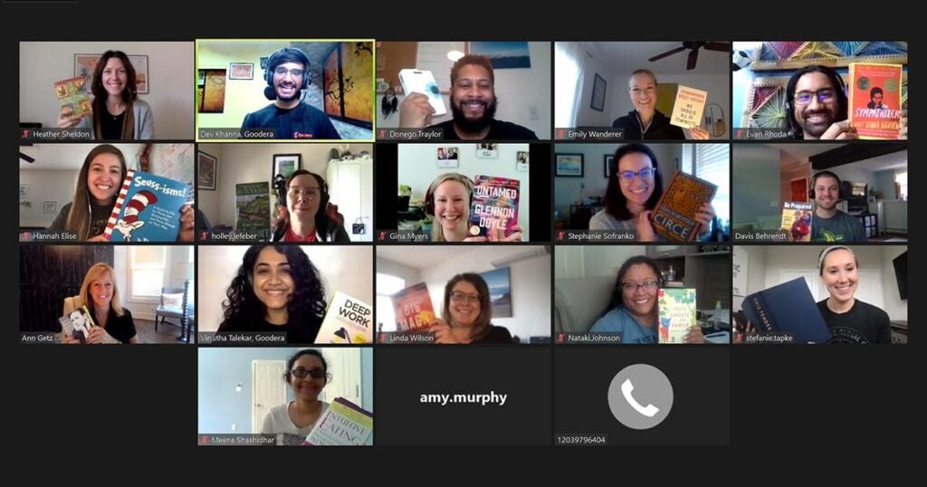 volunteers on a video call holding up books