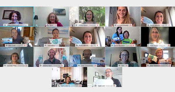 volunteers on a video call holding up safety equipment