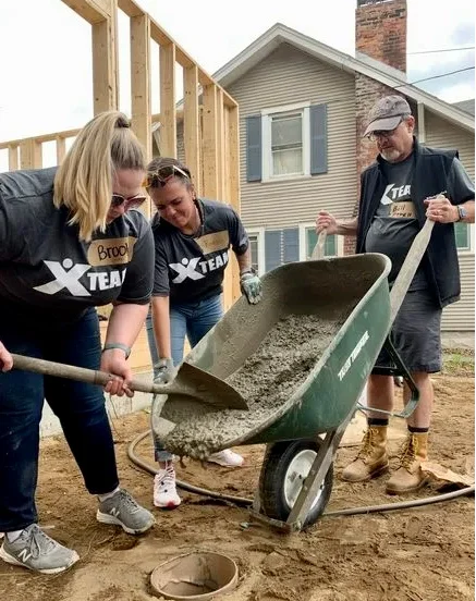 Berkshire Bank employees pouring concrete volunteering.